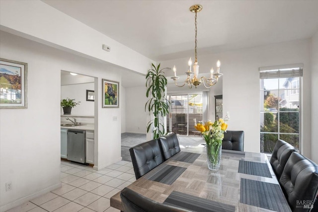 tiled dining area with an inviting chandelier, plenty of natural light, and sink