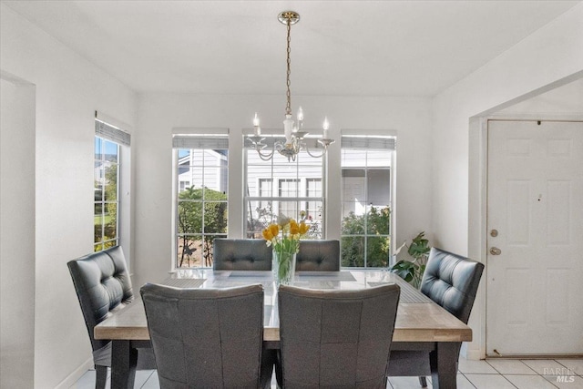 dining area with a chandelier and light tile patterned floors