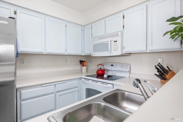 kitchen with white cabinets, white appliances, and sink