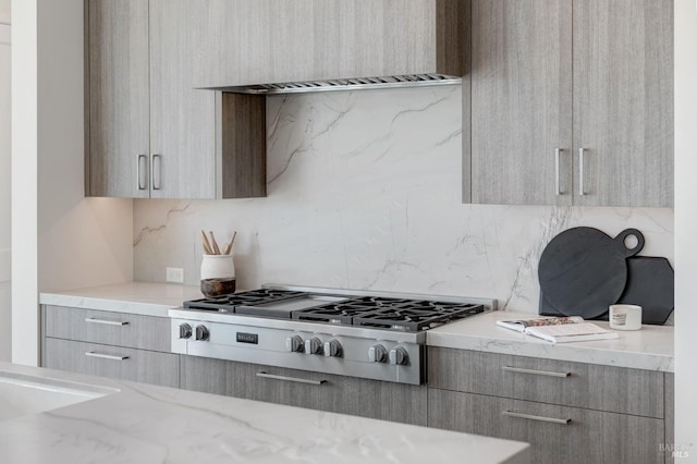 kitchen with light stone counters, stainless steel gas cooktop, and light brown cabinetry