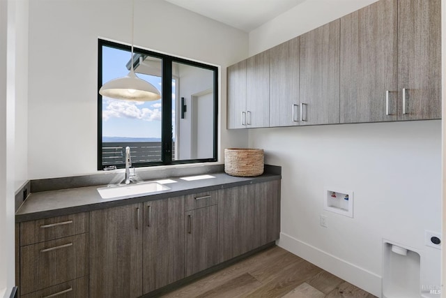 washroom featuring cabinets, washer hookup, dark hardwood / wood-style floors, and sink