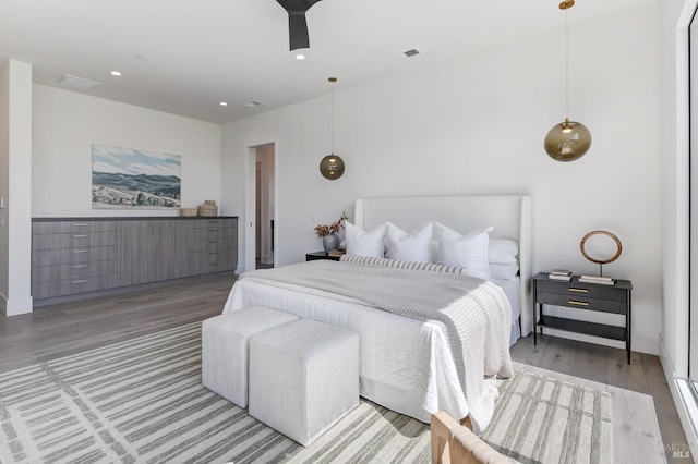 bedroom with wood-type flooring and ceiling fan