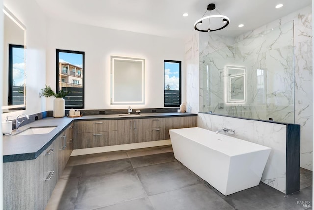 bathroom featuring vanity, plus walk in shower, and plenty of natural light