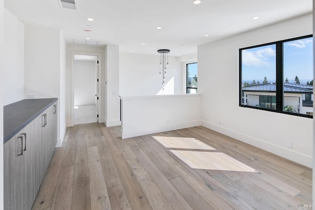 unfurnished room with light hardwood / wood-style flooring