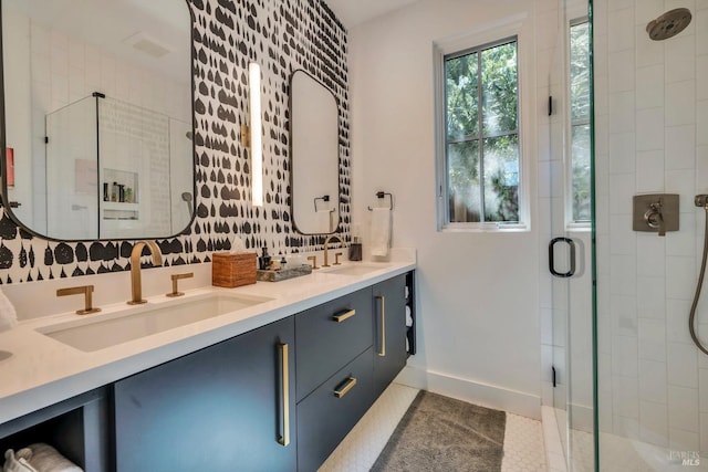 bathroom featuring tile patterned flooring, an enclosed shower, and vanity