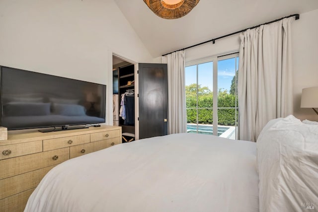 bedroom featuring access to exterior, a closet, and vaulted ceiling