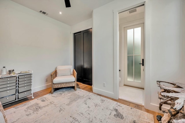 sitting room with wood-type flooring