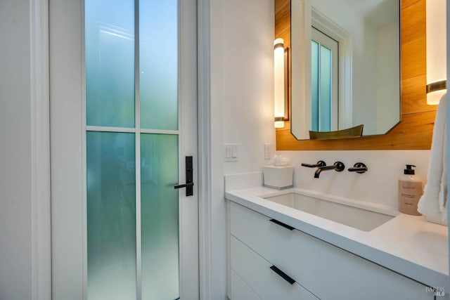 bathroom featuring vanity and an enclosed shower