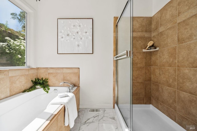 bathroom with separate shower and tub