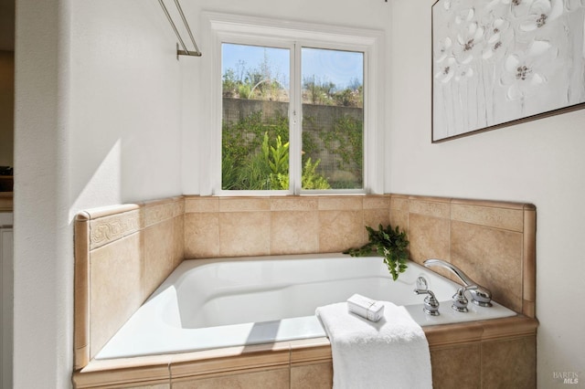 bathroom featuring a wealth of natural light and tiled tub