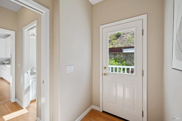 doorway with light hardwood / wood-style flooring