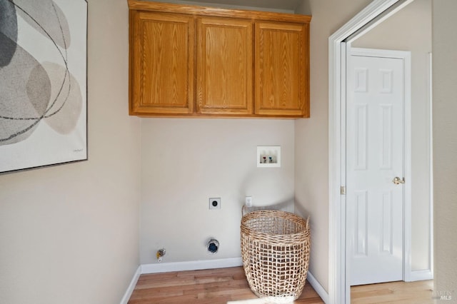 clothes washing area featuring cabinets, washer hookup, electric dryer hookup, light hardwood / wood-style flooring, and hookup for a gas dryer