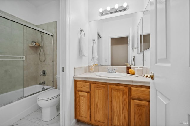 full bathroom with vanity, toilet, and bath / shower combo with glass door