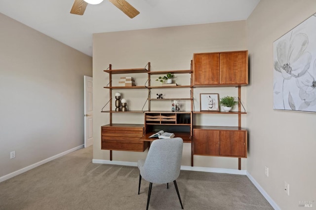 office area featuring light carpet and ceiling fan