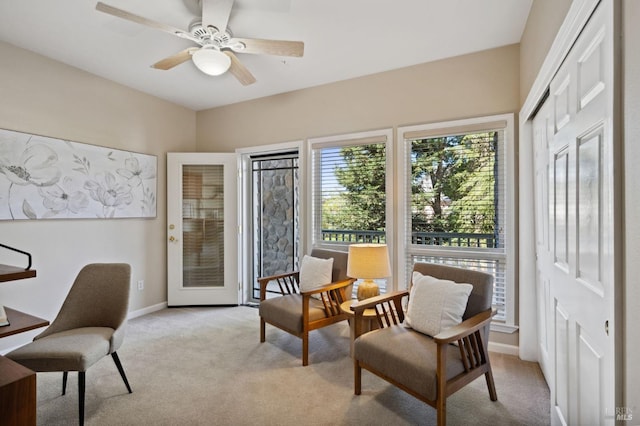 sitting room with light carpet and ceiling fan