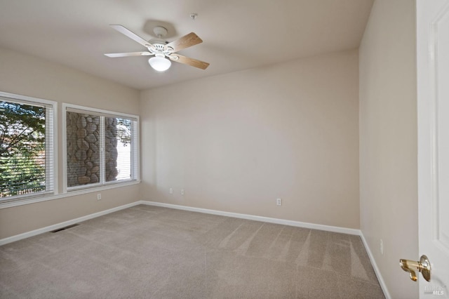 empty room with light carpet and ceiling fan