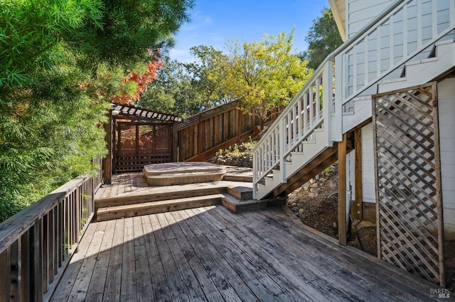 wooden terrace featuring a covered hot tub