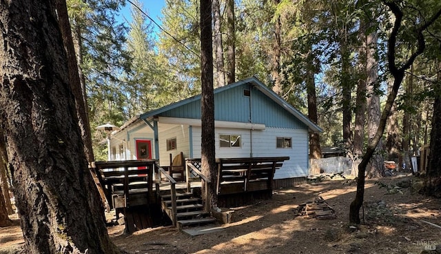 back of house featuring a deck