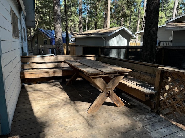 deck with outdoor dining area and fence