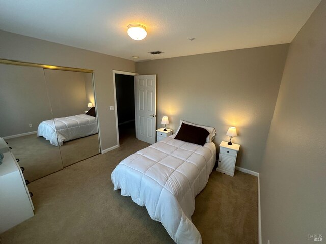 bedroom featuring light colored carpet, a raised ceiling, and ornamental molding