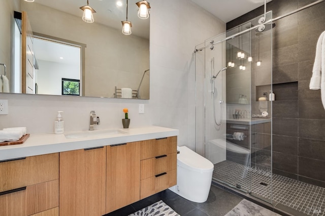 bathroom featuring toilet, a stall shower, and vanity
