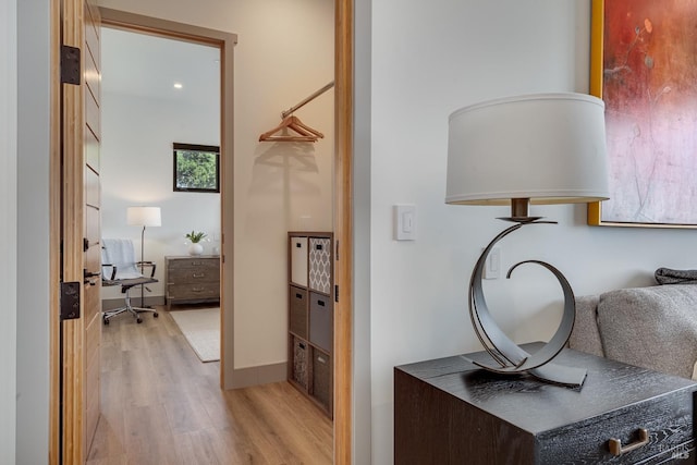 interior space featuring baseboards and light wood-type flooring