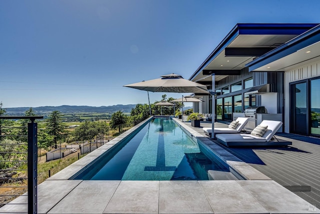 view of pool with a mountain view and a fenced in pool