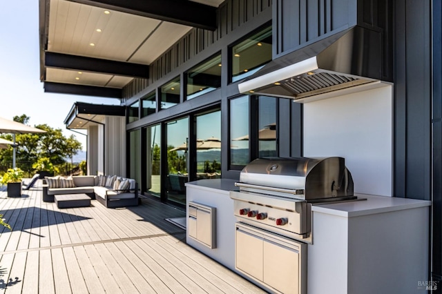 deck featuring outdoor lounge area, exterior kitchen, and area for grilling