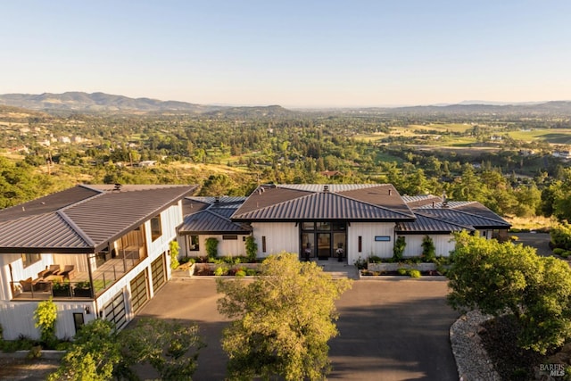 view of building exterior with a garage and a mountain view