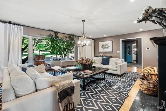 living room with recessed lighting, a notable chandelier, and wood finished floors