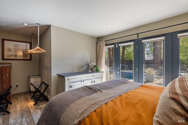 bedroom with access to exterior, recessed lighting, baseboards, and wood finished floors