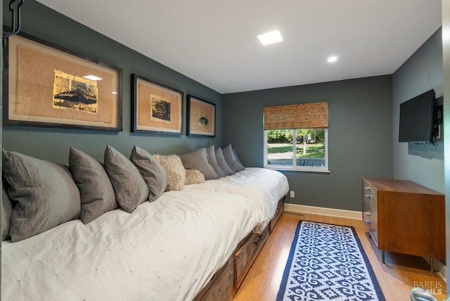 bedroom featuring baseboards and light wood-type flooring