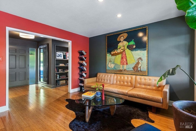 living room with baseboards and wood-type flooring