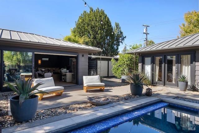 exterior space featuring a patio area, french doors, and an outdoor structure