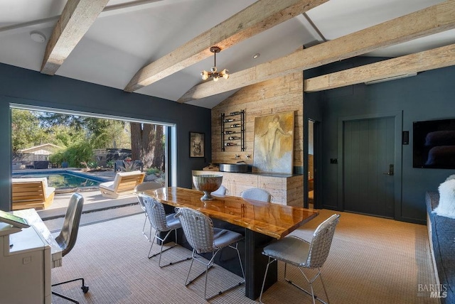 dining space with a notable chandelier, vaulted ceiling with beams, and carpet flooring