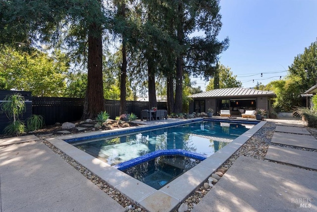 view of swimming pool featuring a gazebo, a patio, a pool with connected hot tub, and a fenced backyard