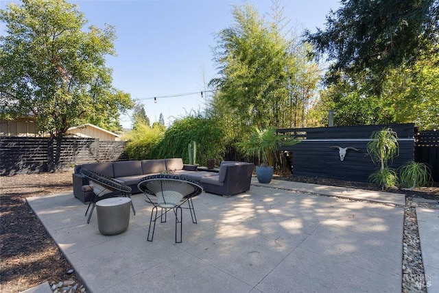 view of patio / terrace featuring outdoor lounge area and fence