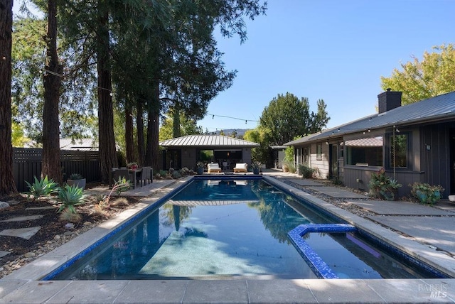 view of pool with a gazebo, fence, a pool with connected hot tub, and a patio