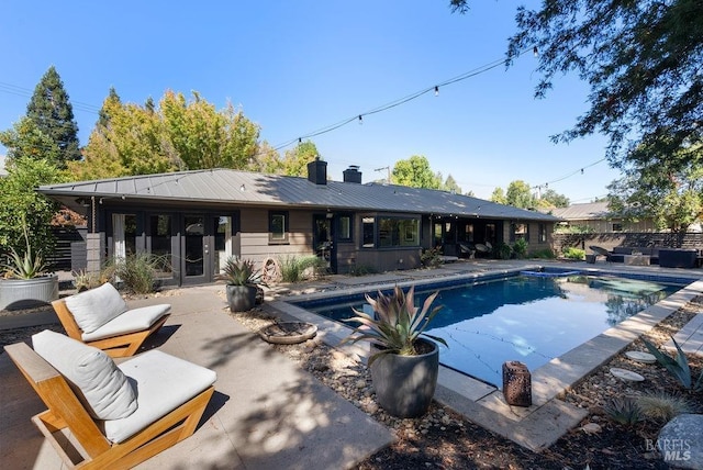 view of swimming pool with a patio area, an outdoor living space, a fenced in pool, and fence