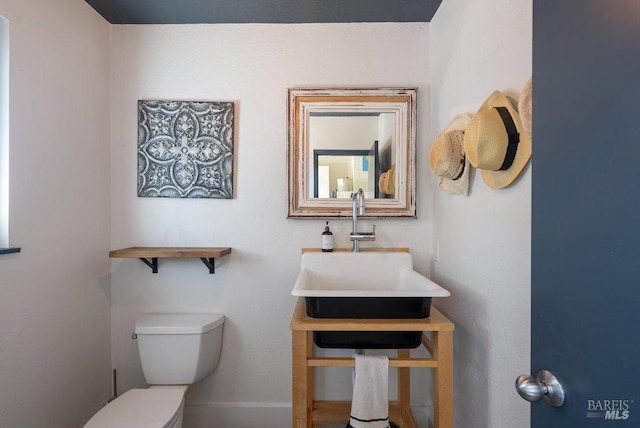 bathroom with toilet and a sink