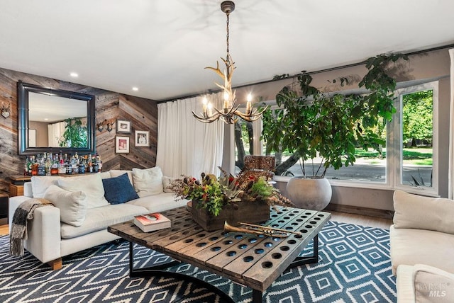 living area featuring recessed lighting, wood walls, an inviting chandelier, and wood finished floors