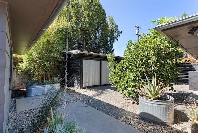 exterior space with an outbuilding and fence