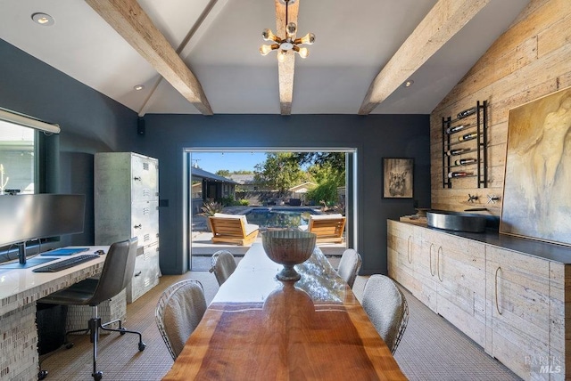 dining area featuring a notable chandelier and lofted ceiling with beams