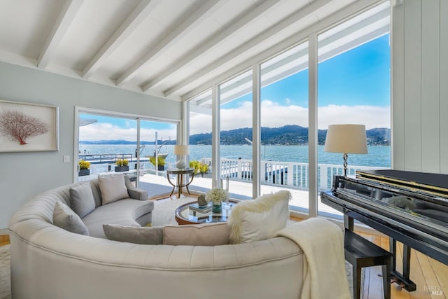 living room featuring beamed ceiling, a water and mountain view, and hardwood / wood-style floors