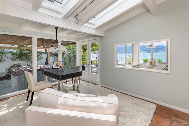 sunroom with french doors and lofted ceiling with skylight