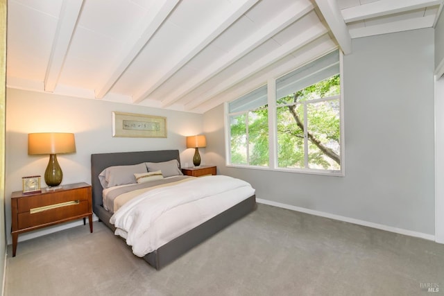 carpeted bedroom featuring vaulted ceiling with beams