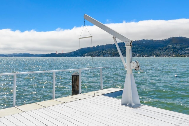 view of dock with a water and mountain view