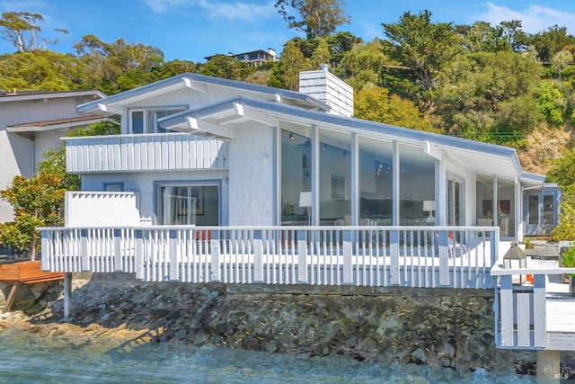 back of property with a sunroom