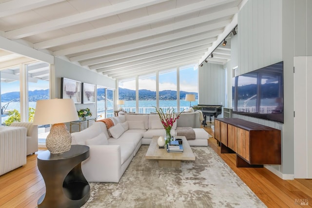 sunroom / solarium featuring lofted ceiling with beams