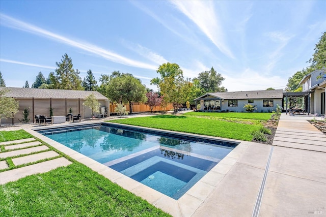 view of swimming pool with an in ground hot tub, a yard, and a patio